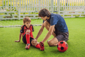 youung child with leg injury from playing soccer