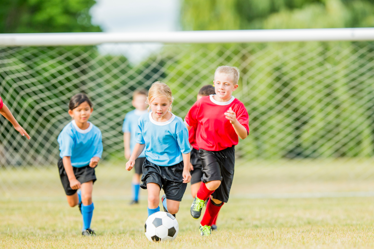 young kids playing soccer