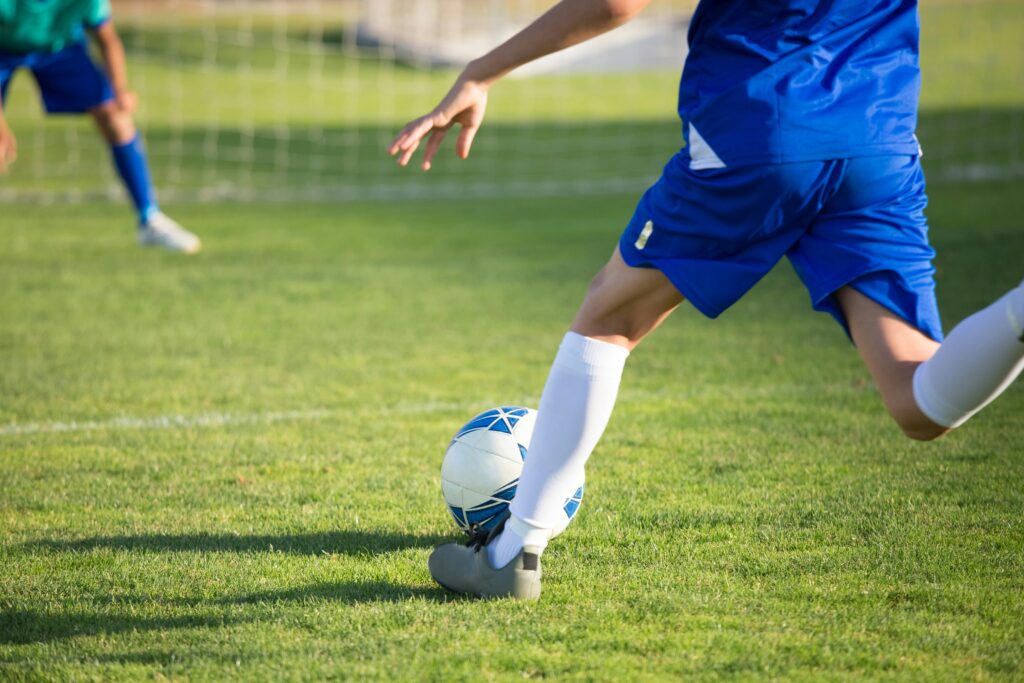 what age should kids start playing soccer - kid dribbles the ball