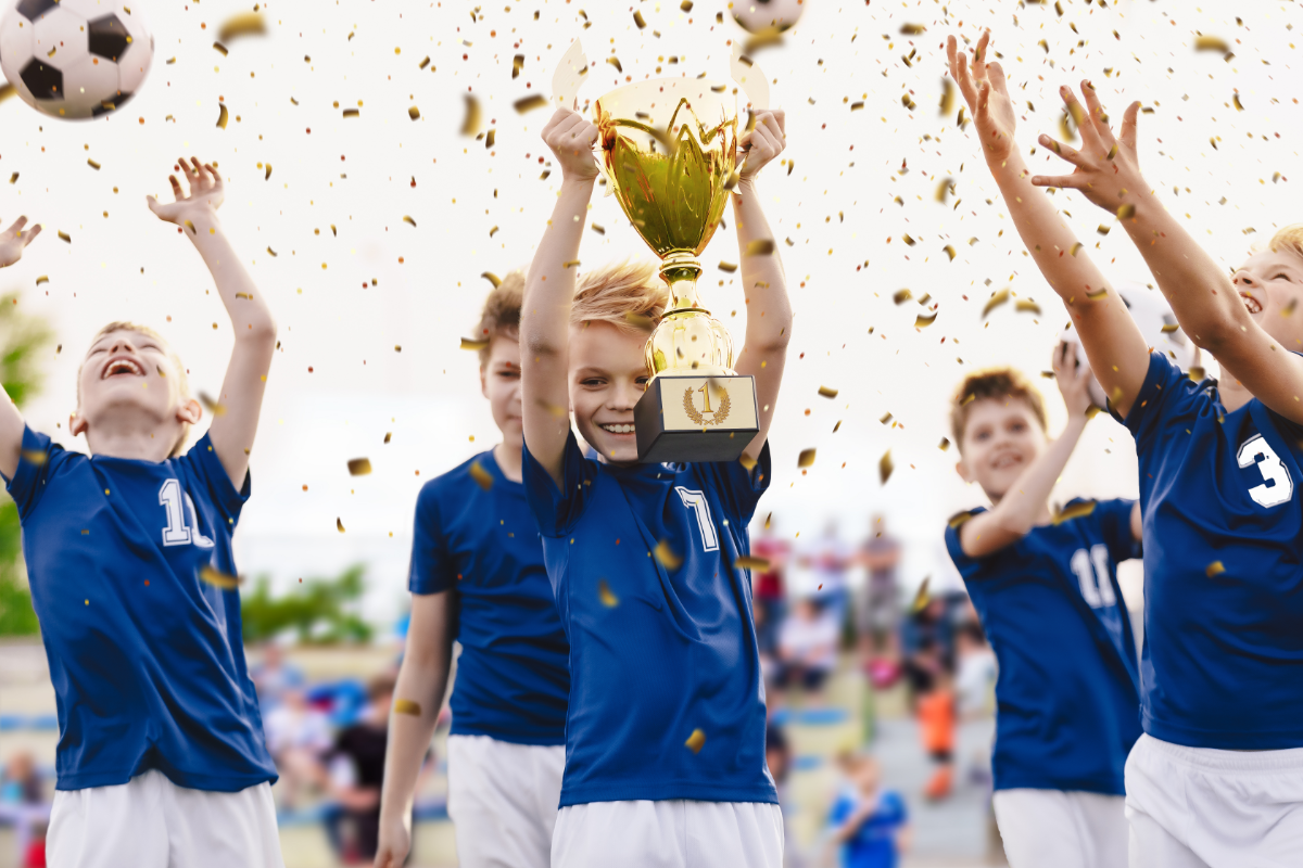 young team celebrating a championship with a trophy