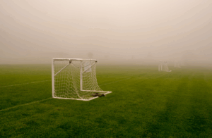 small goal in fog on soccer field