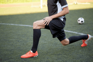 soccer player stretching before the game